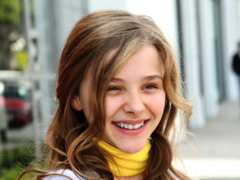 smiling young girl with brown hair