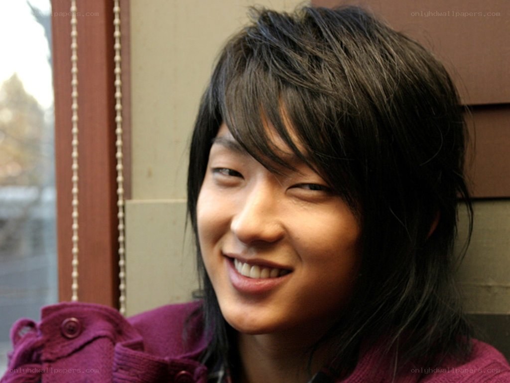 smiling young man in purple jacket