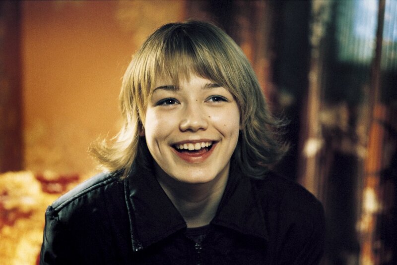 smiling young person with blonde hair