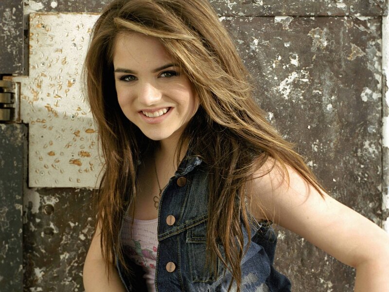 smiling young woman in denim vest