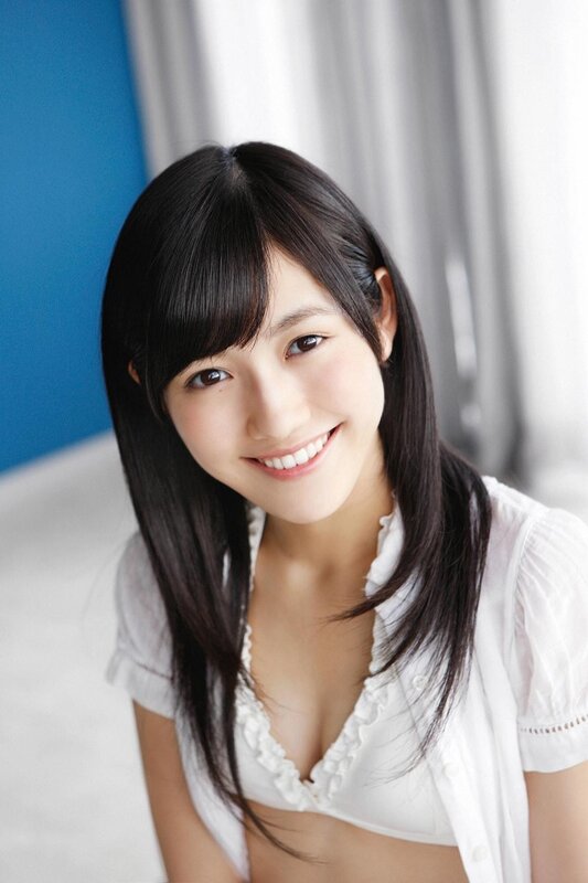 Smiling young woman in white blouse