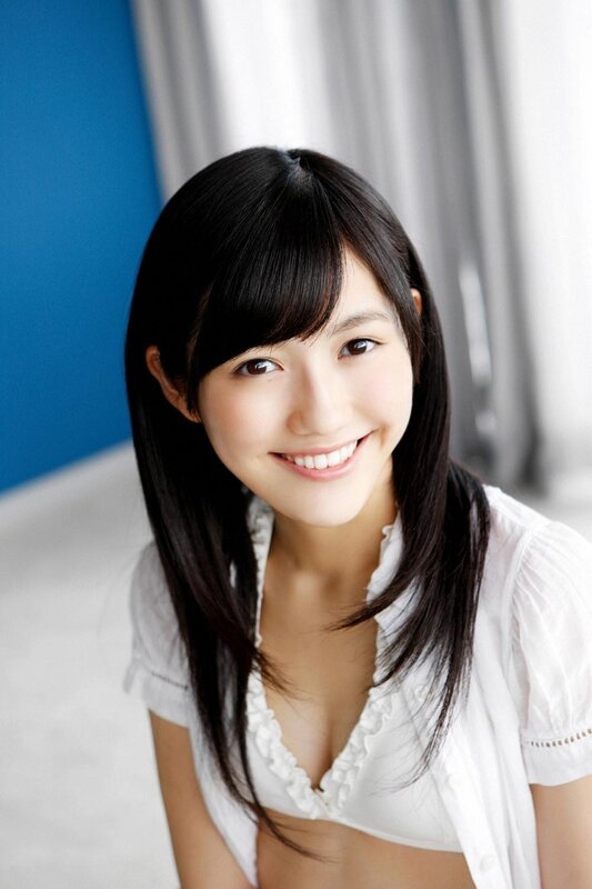 Smiling young woman in white blouse