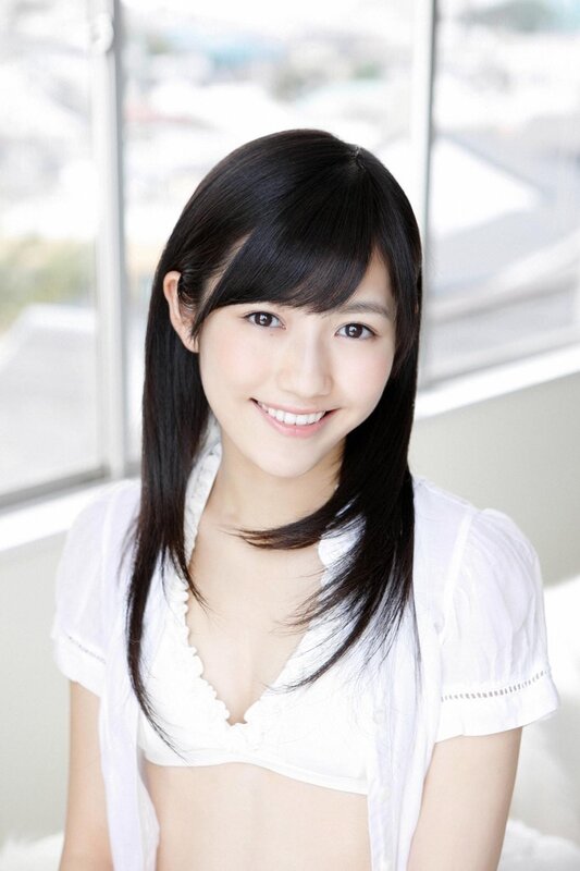 Smiling young woman in white shirt