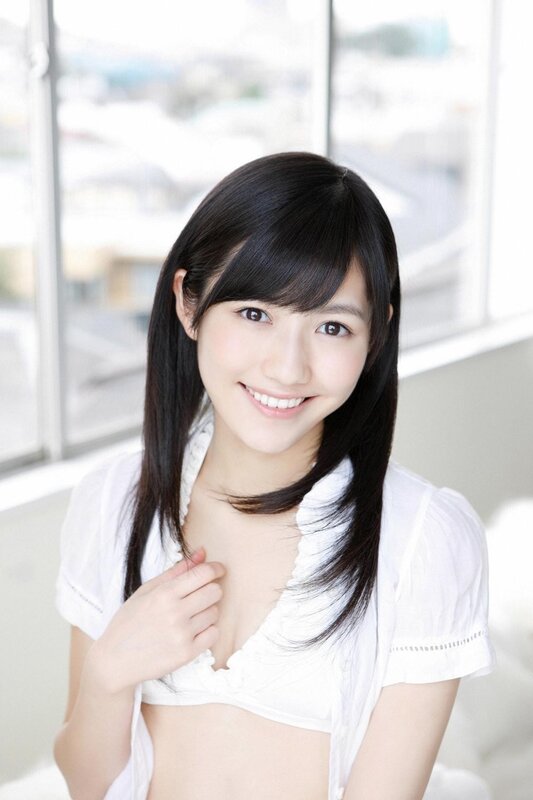 Smiling young woman in white