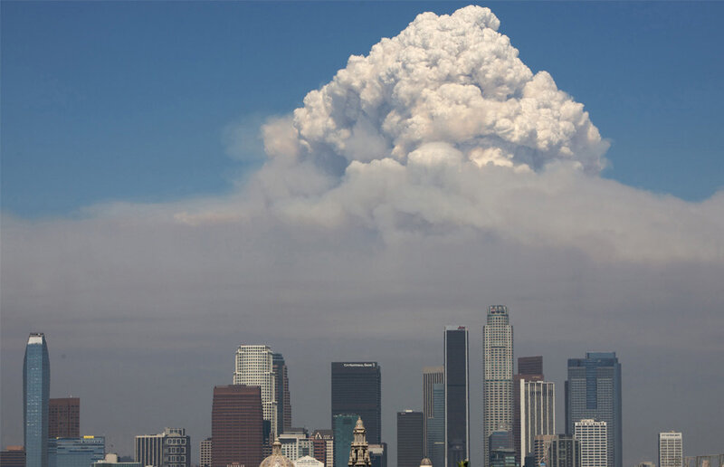 Smoke cloud over city skyline