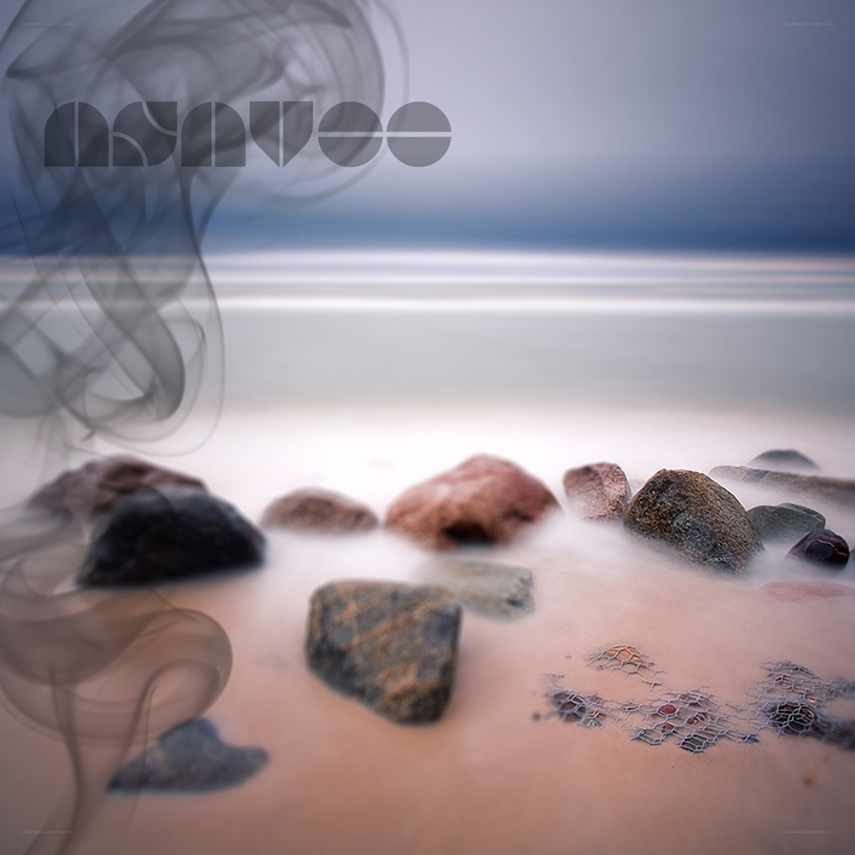 Smoke over beach rocks