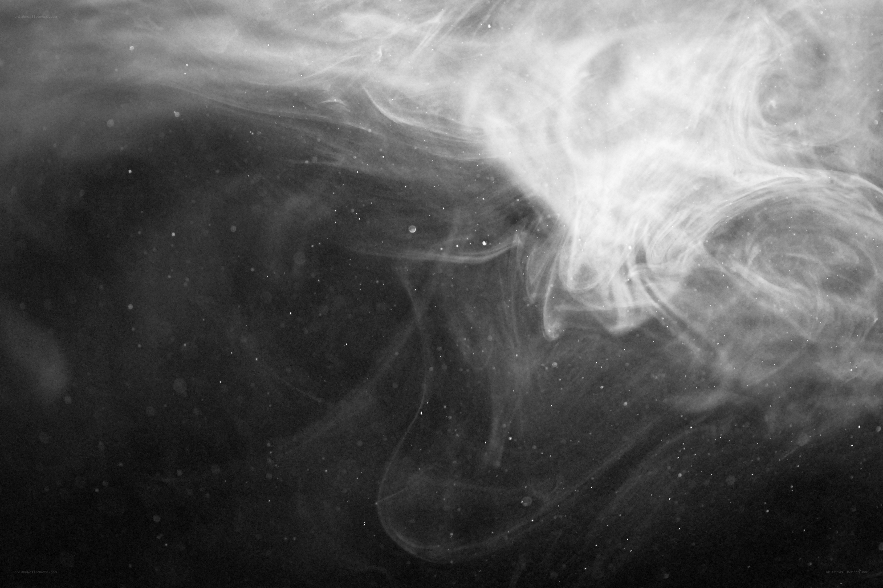 smoke swirls in dark space