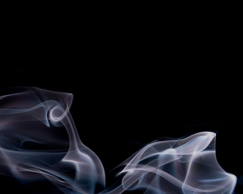 Smoke swirls on black