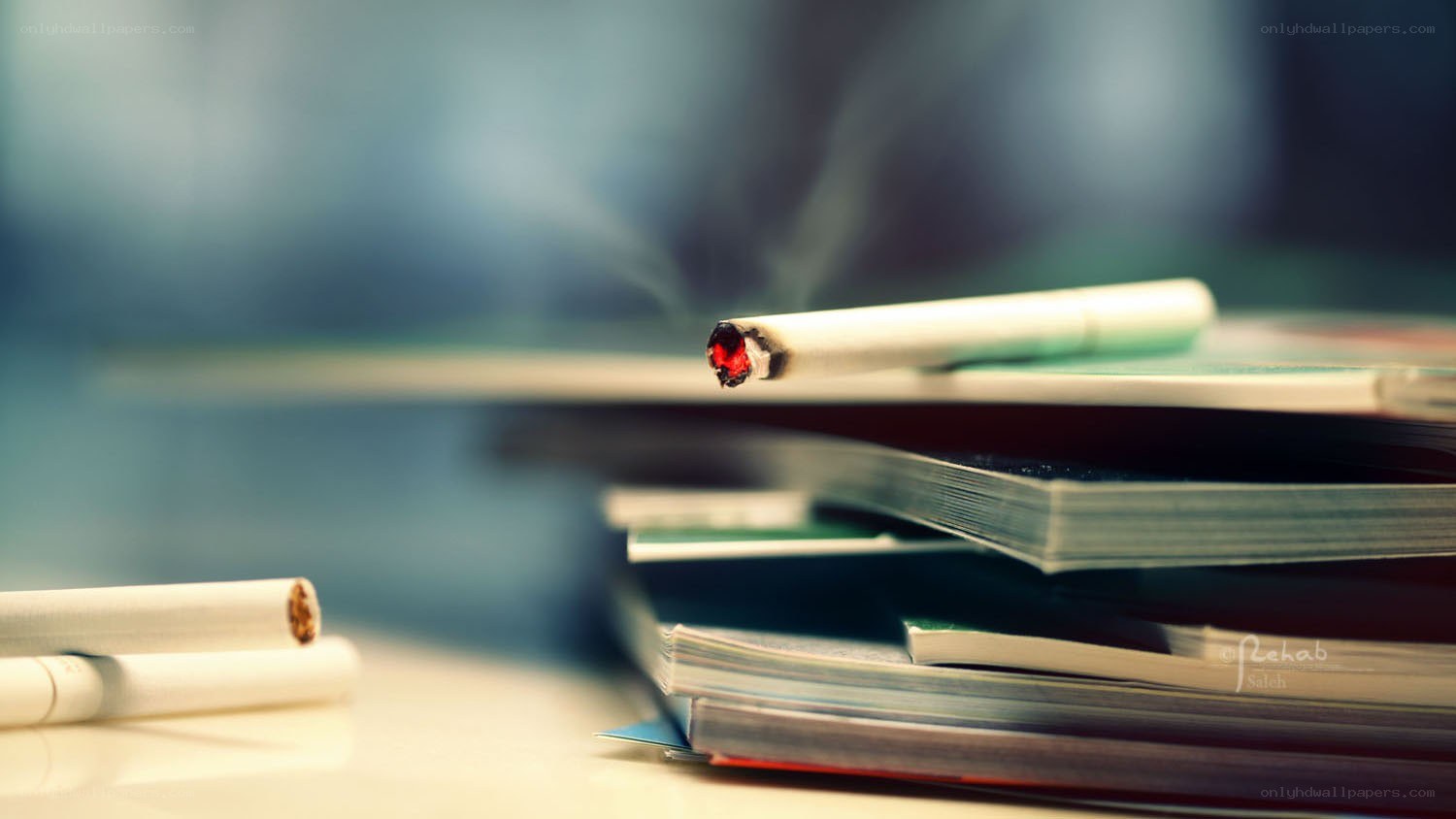 Smoking cigarette on books
