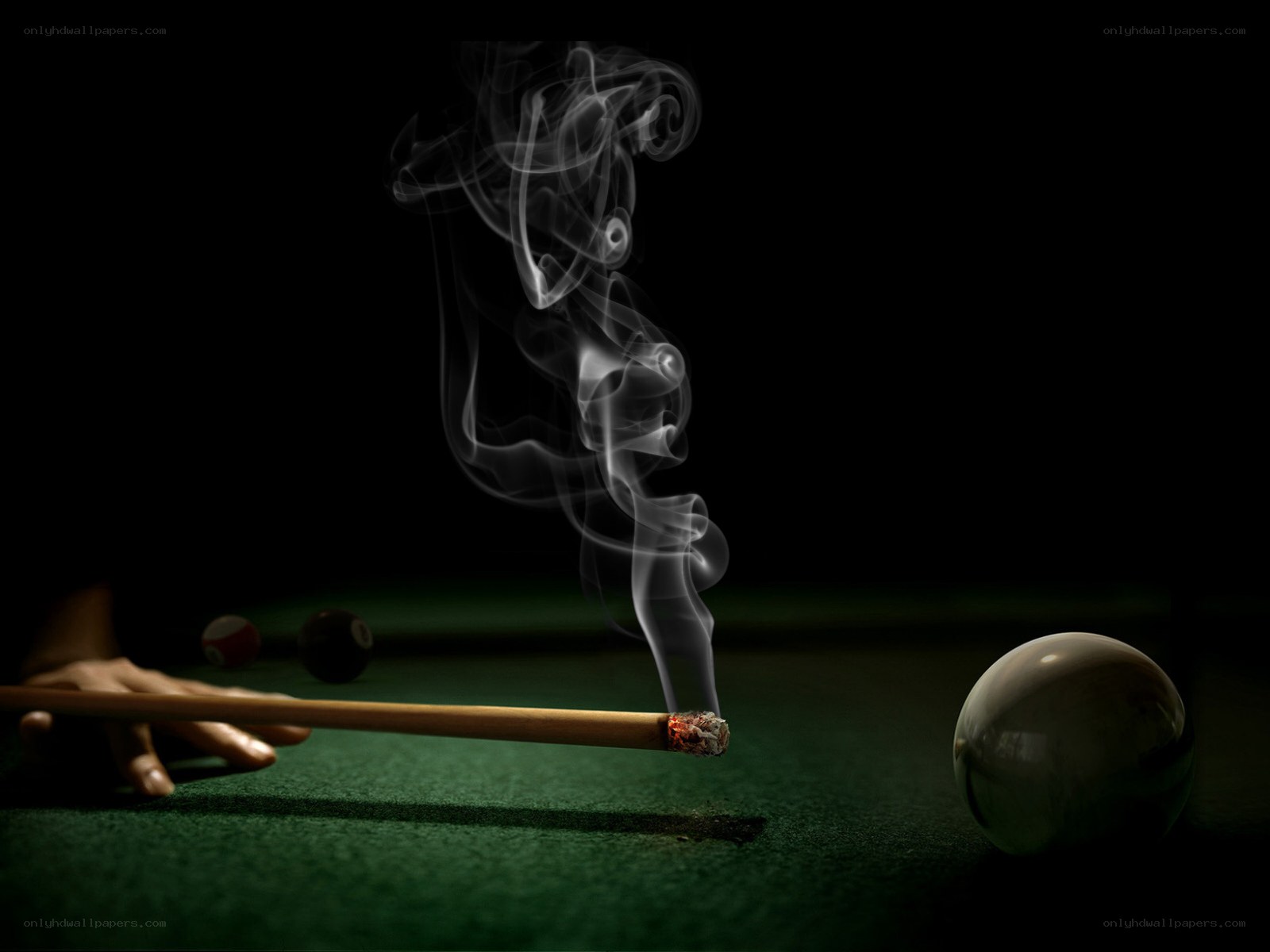 smoking pool cue on green table