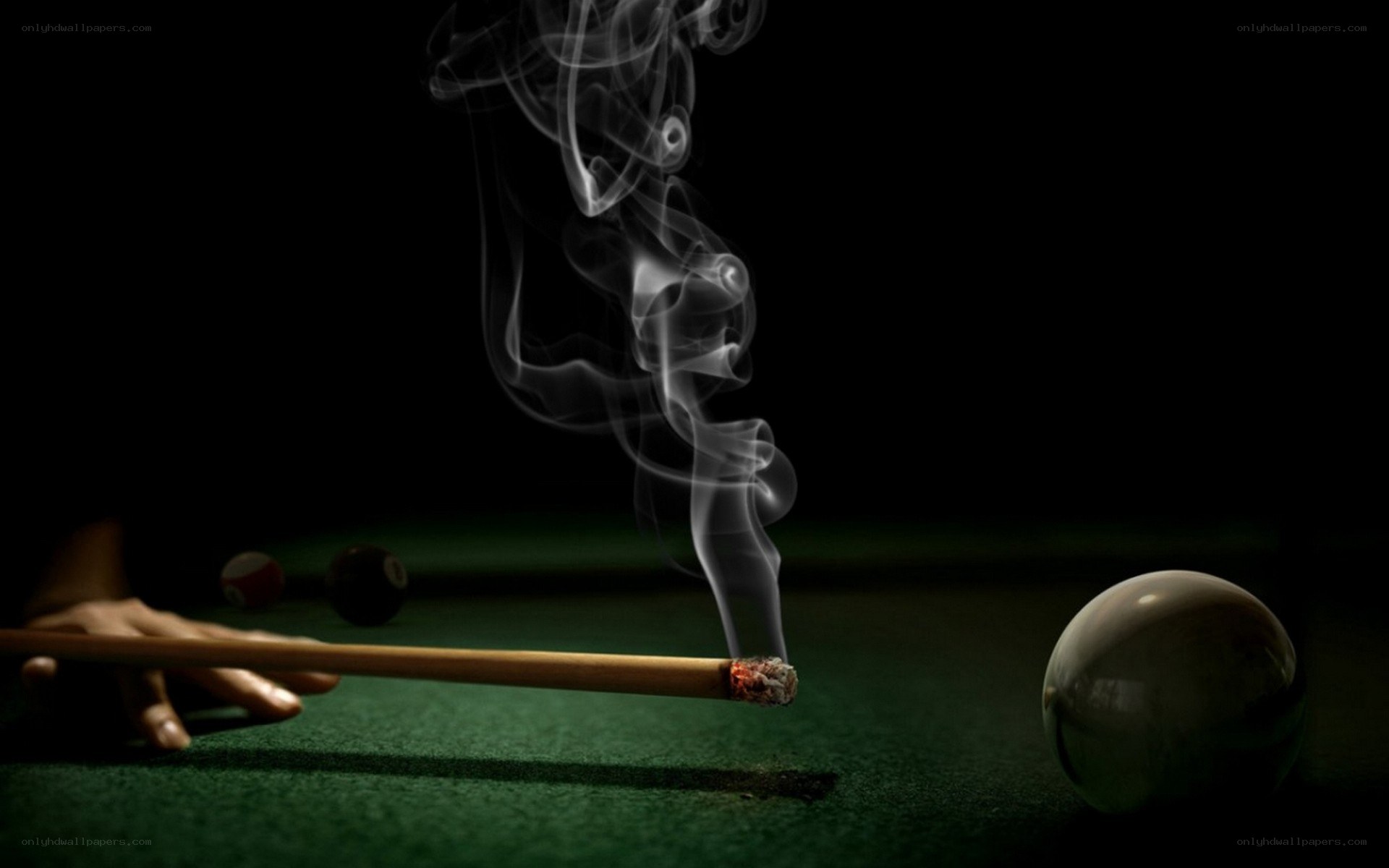 smoking pool cue on green table