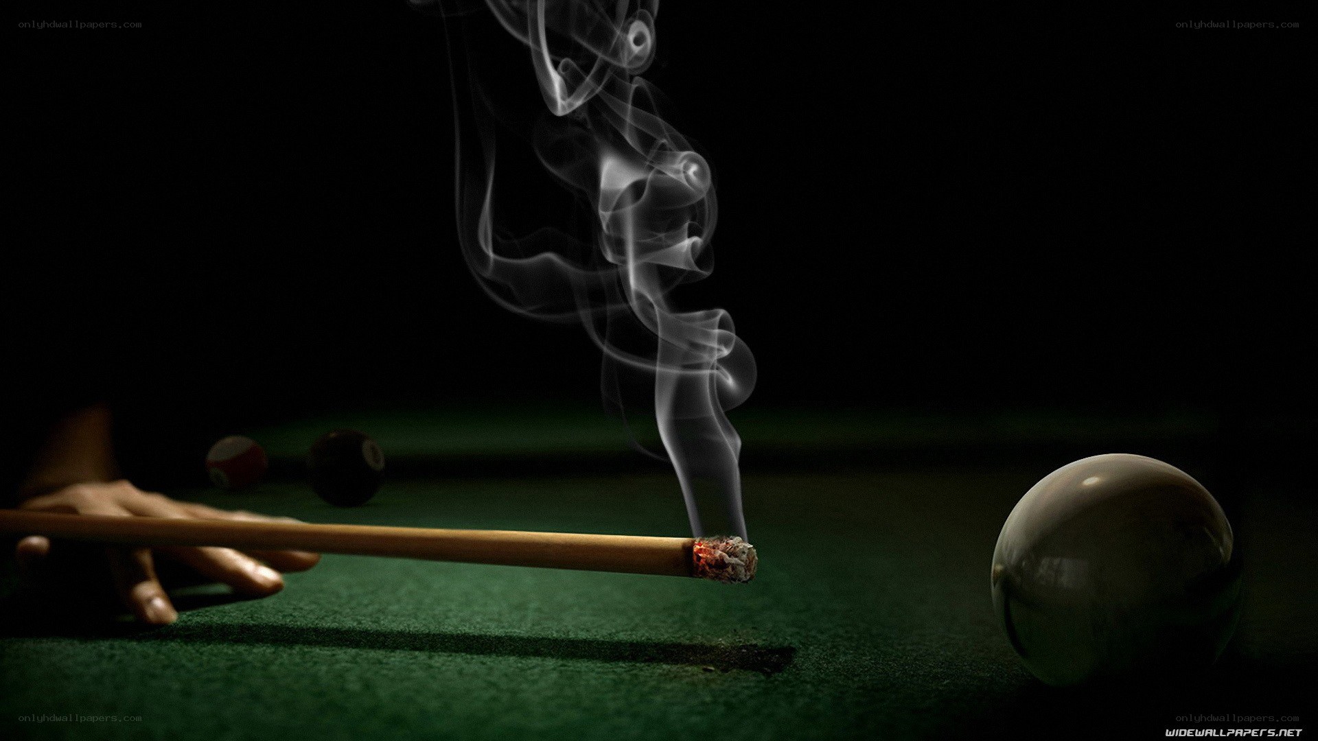 smoking pool cue on green table