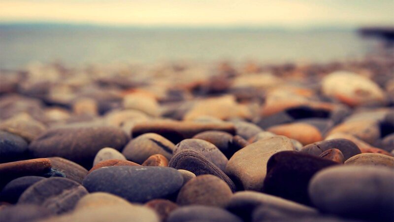 Smooth Pebbles on Beach — Brown
