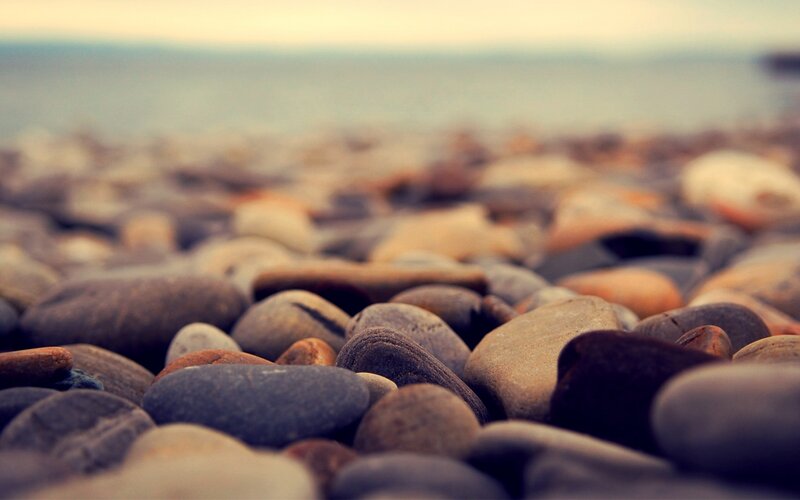Smooth Pebbles on Beach — Gray, Calm, Sunset
