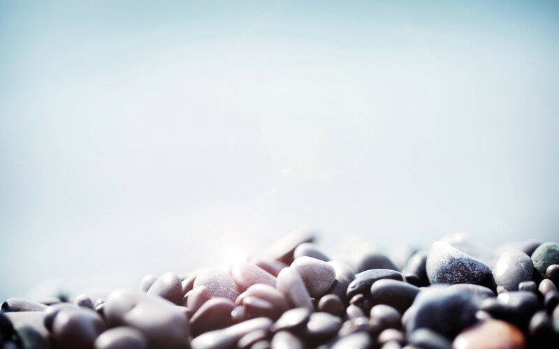 Smooth Pebbles on Beach — Gray