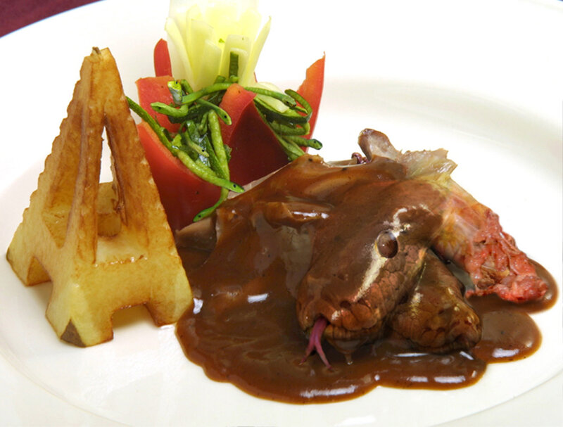 Snake dish with sauce and garnish