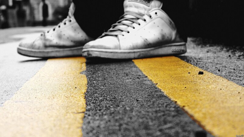 sneakers on yellow lines