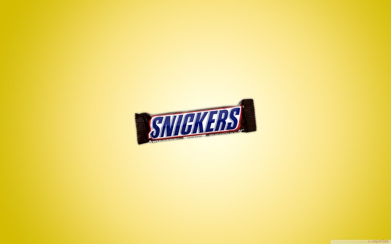 Snickers candy bar on yellow