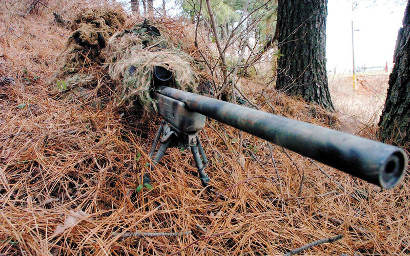 sniper in woodland camouflage