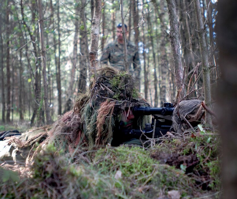 Sniper in woodland camouflage