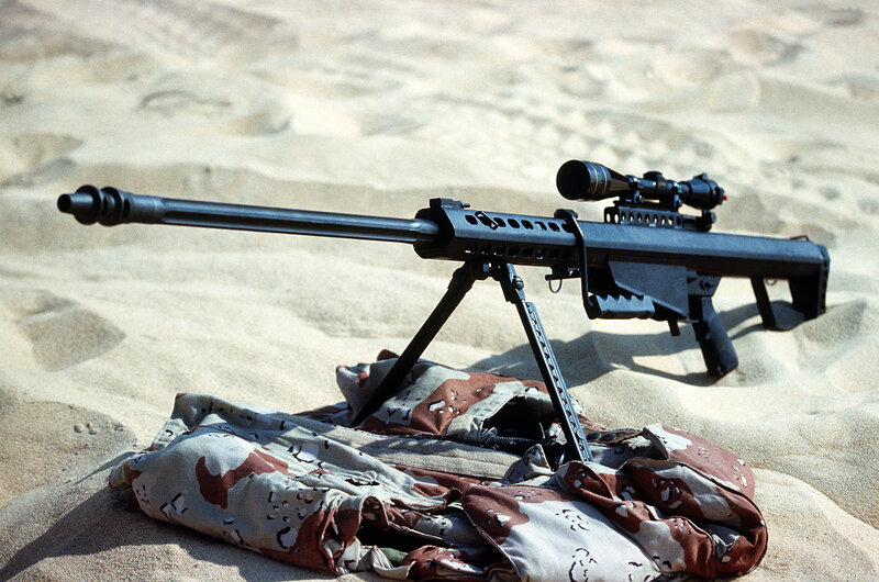 sniper rifle in desert sand