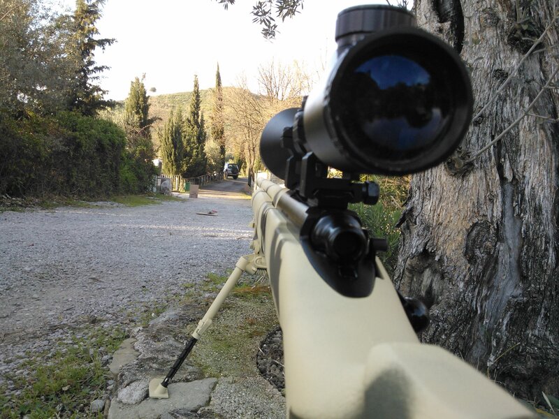 sniper rifle on a gravel path