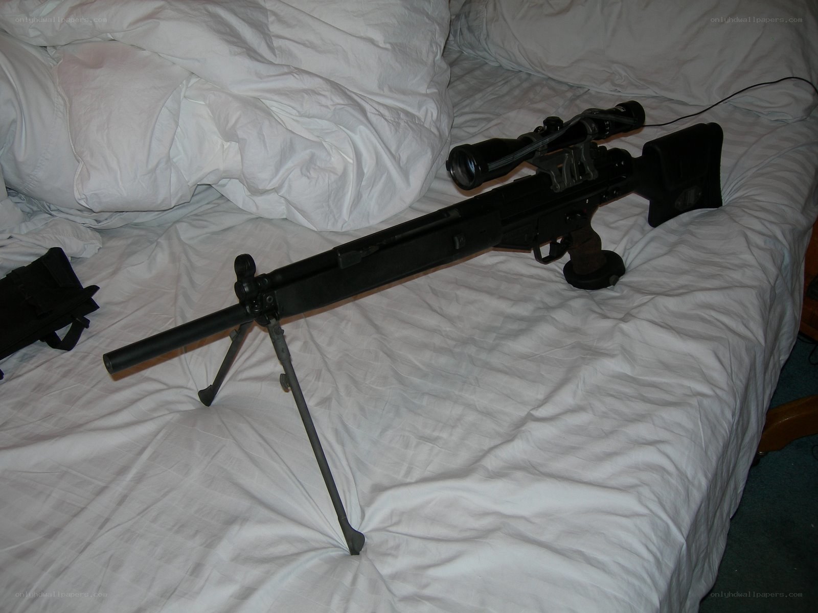 sniper rifle on bed