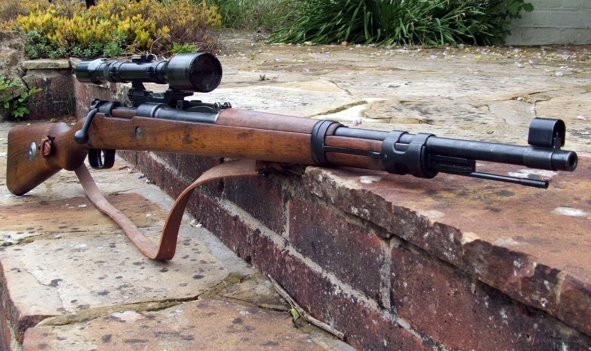 Sniper rifle on brick wall
