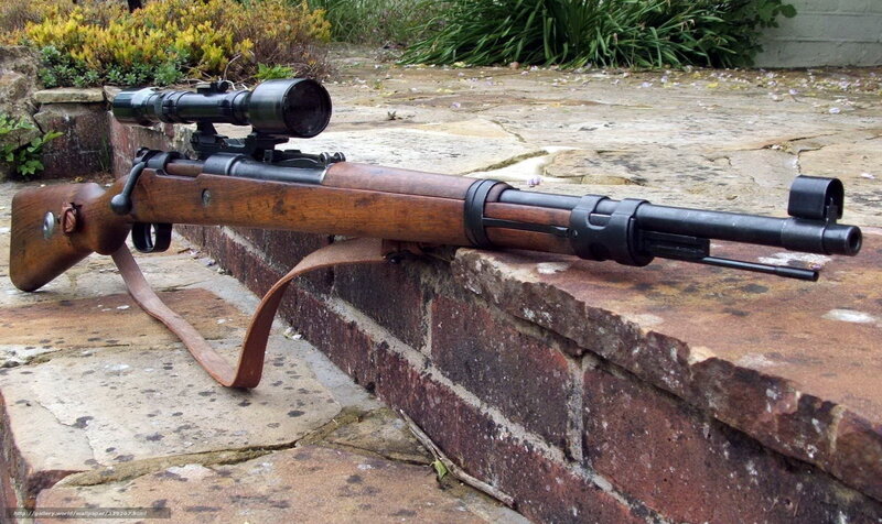 sniper rifle on brick wall