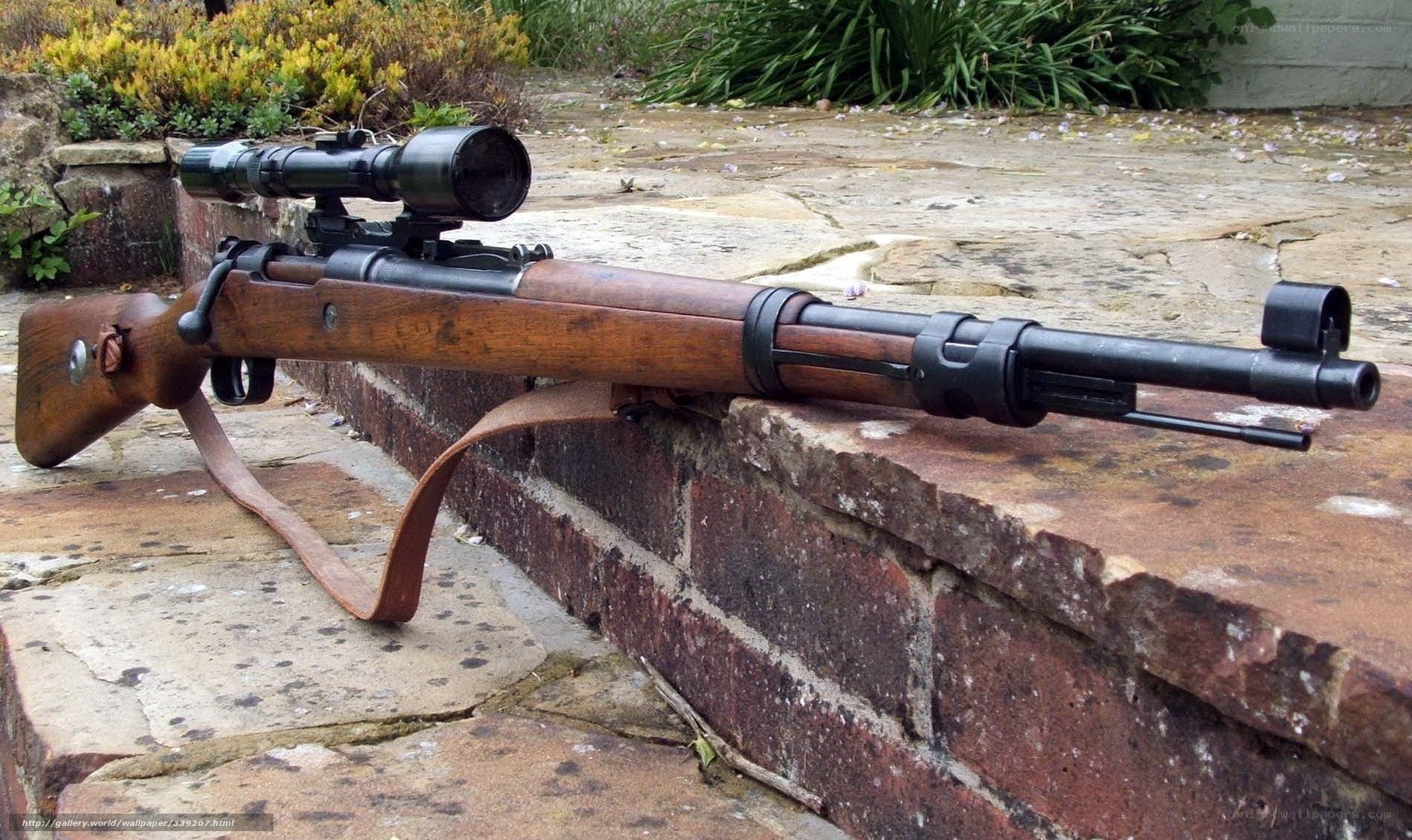 sniper rifle on brick wall