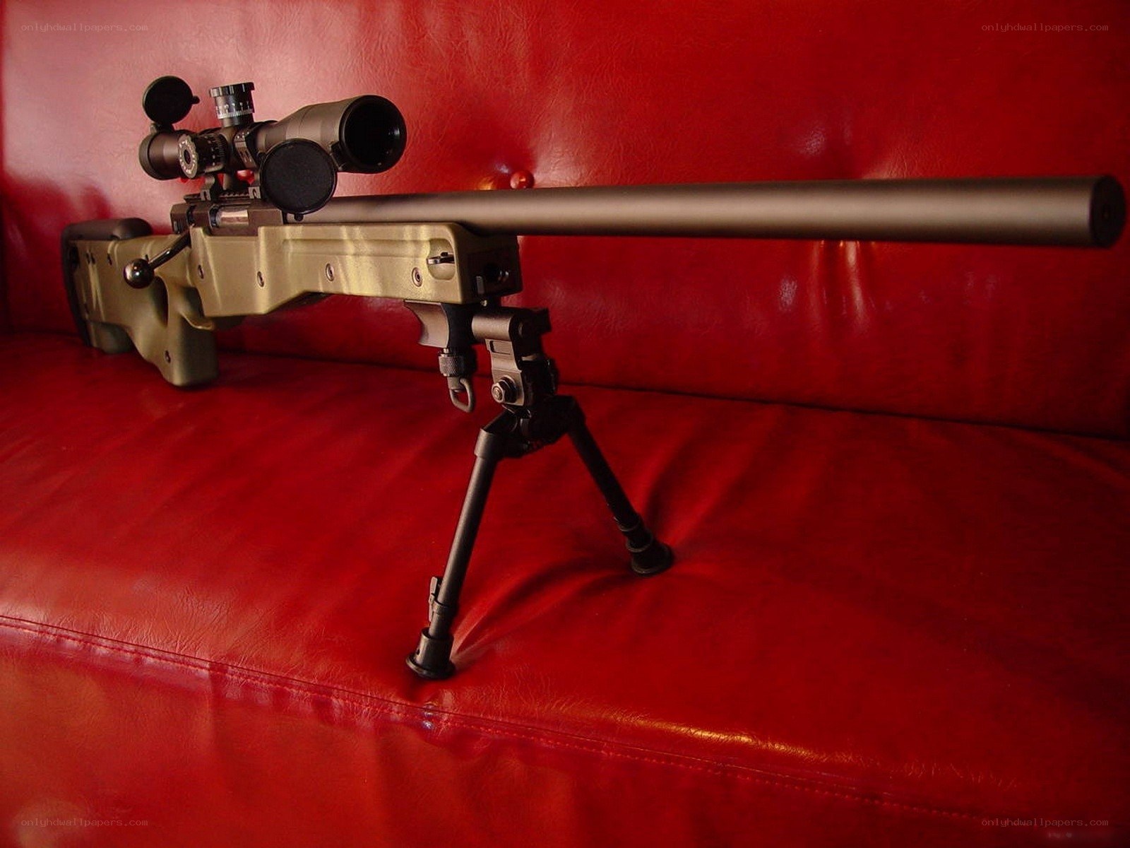 sniper rifle on red couch