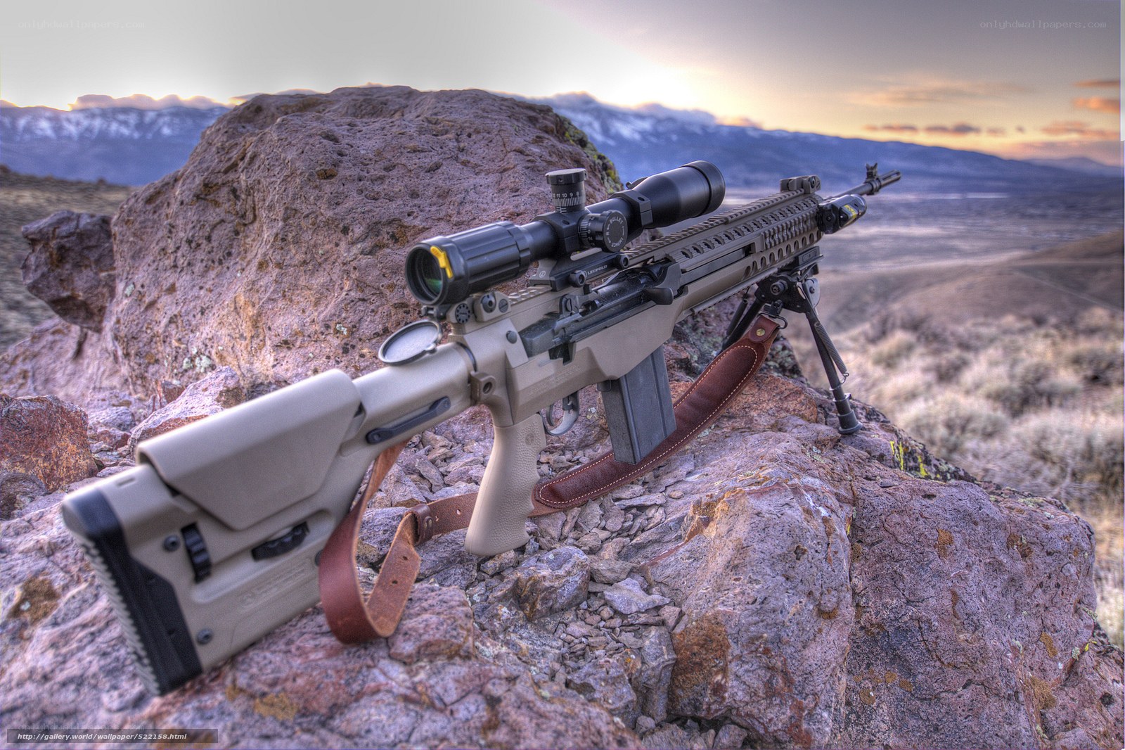 sniper rifle on rocky outcrop