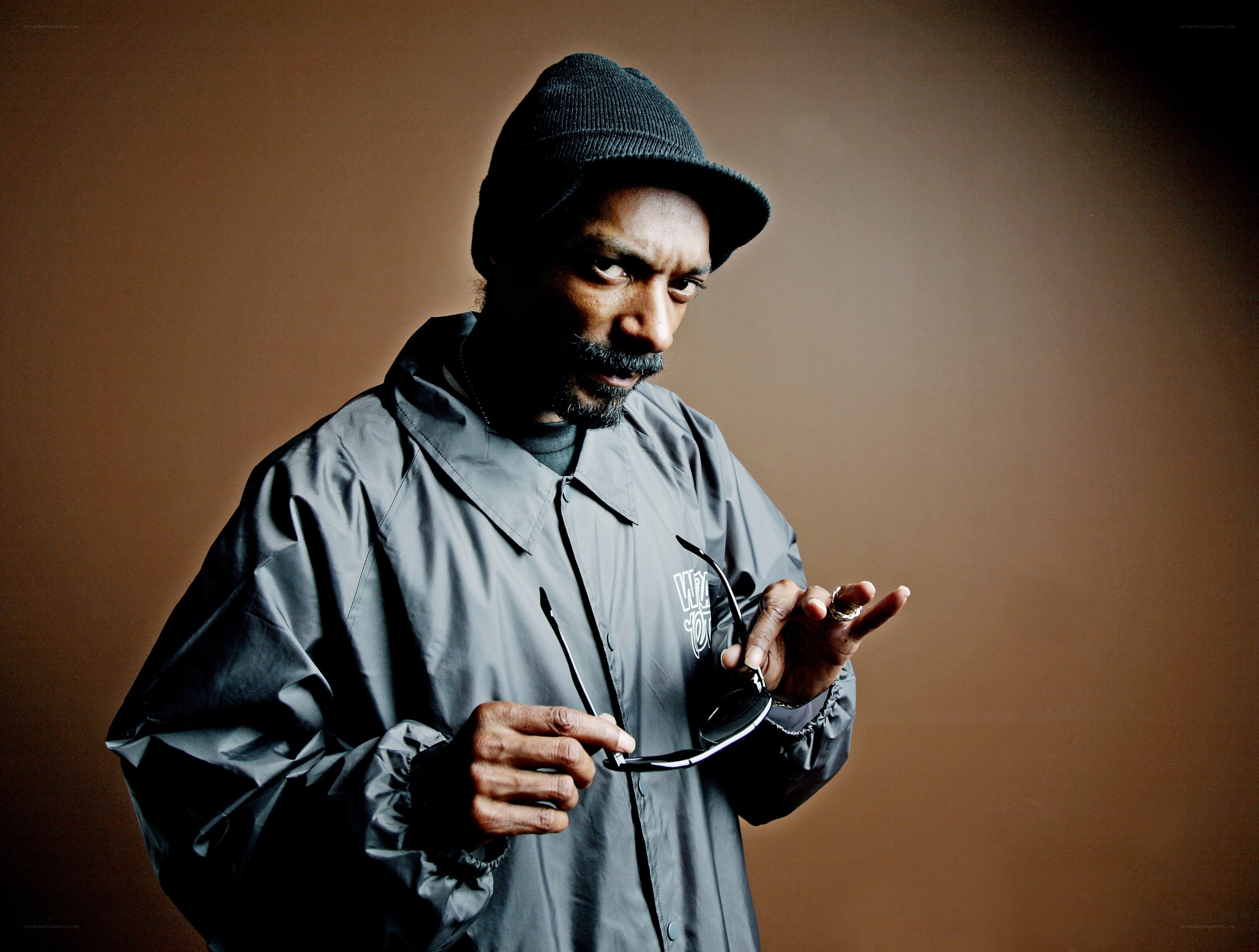 Snoop Dogg holding sunglasses