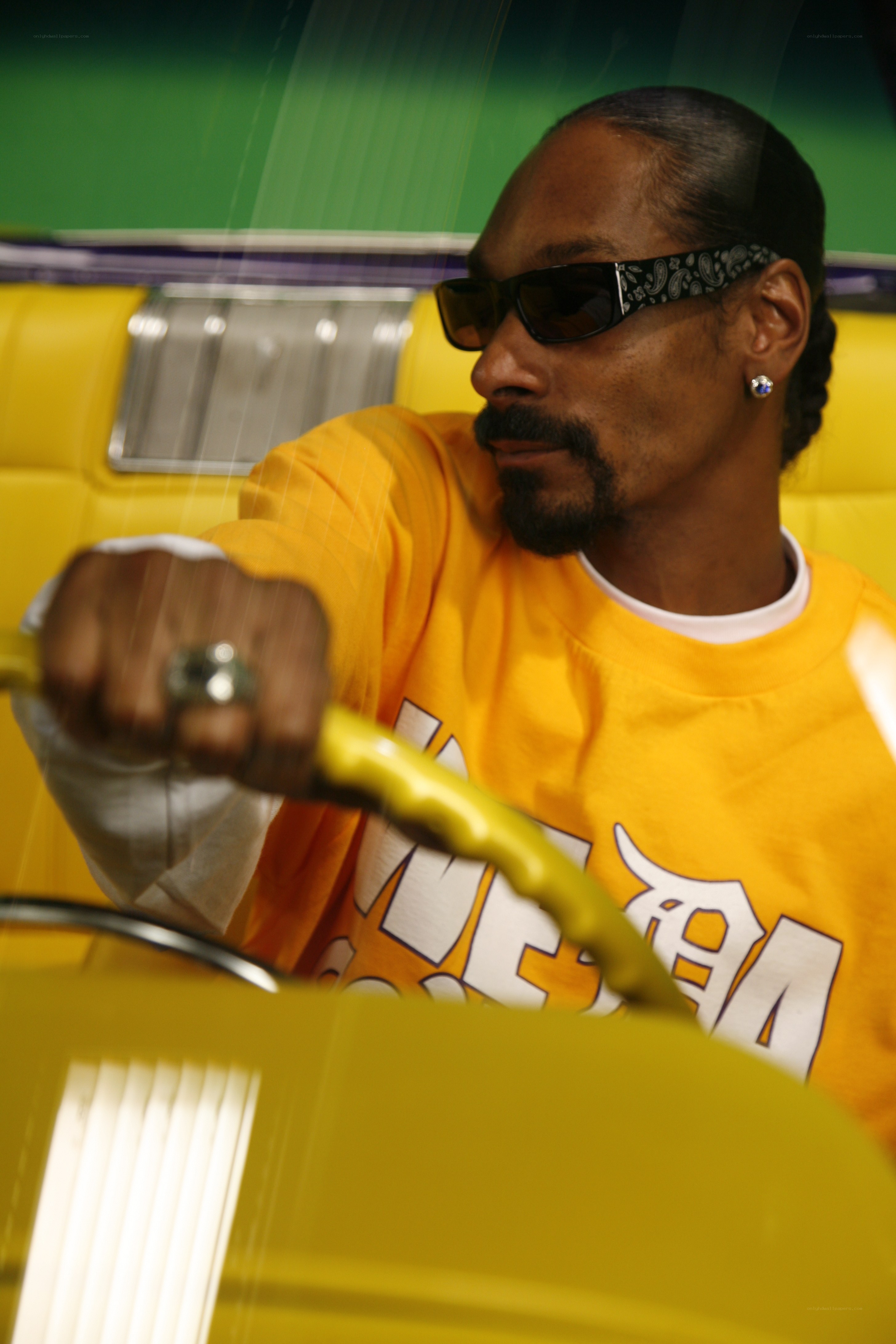 Snoop Dogg in a yellow car