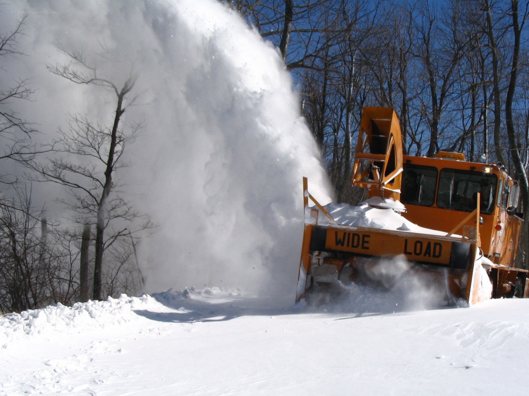 Snow blower clearing a path
