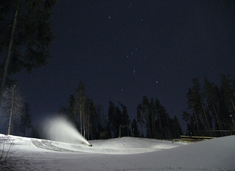 Snow cannon at night under stars