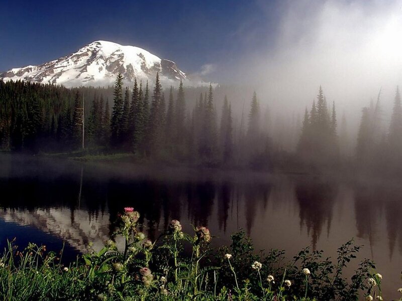 Snow-capped mountain and misty lake