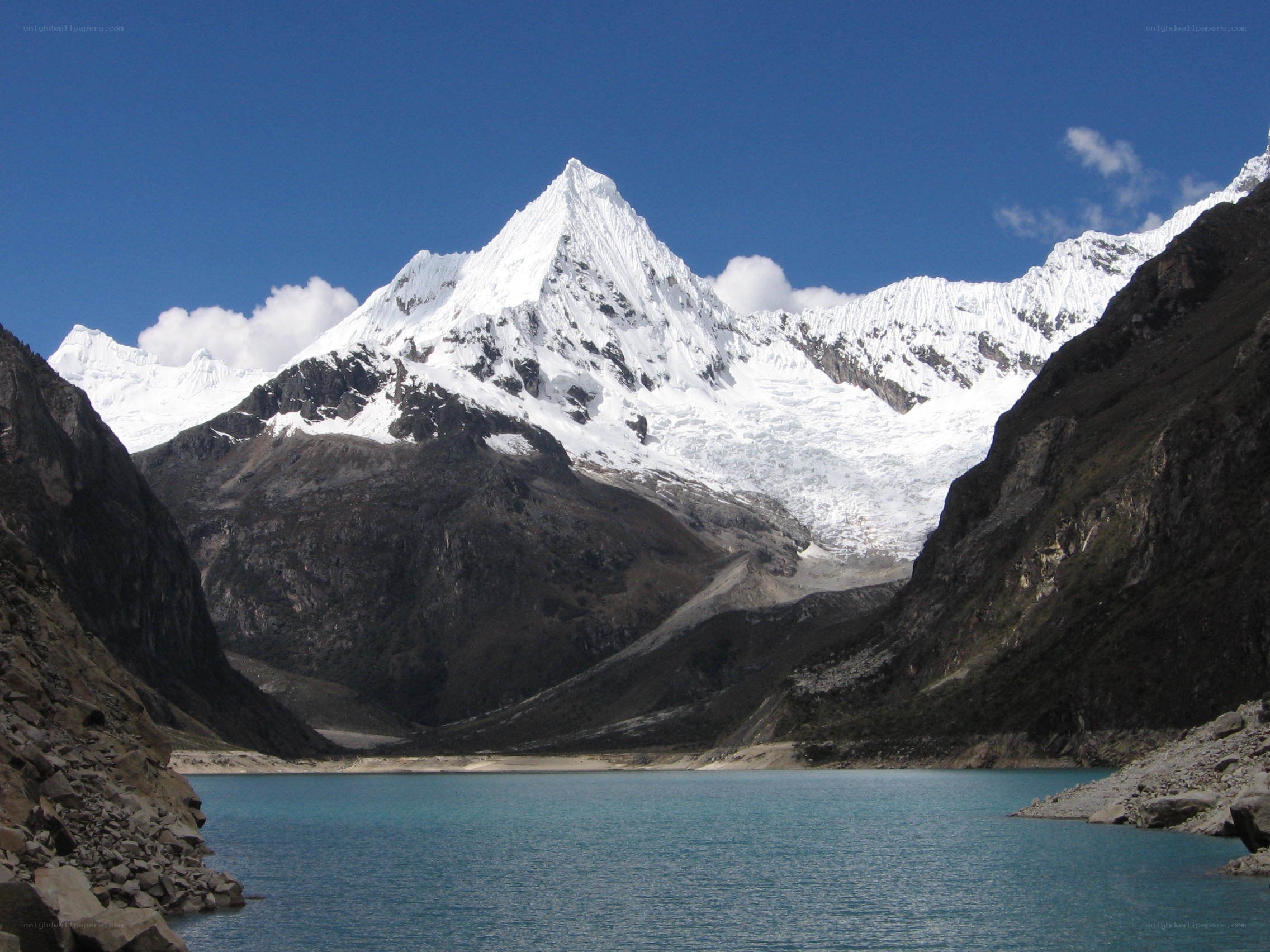 snow-capped mountain and turquoise lake