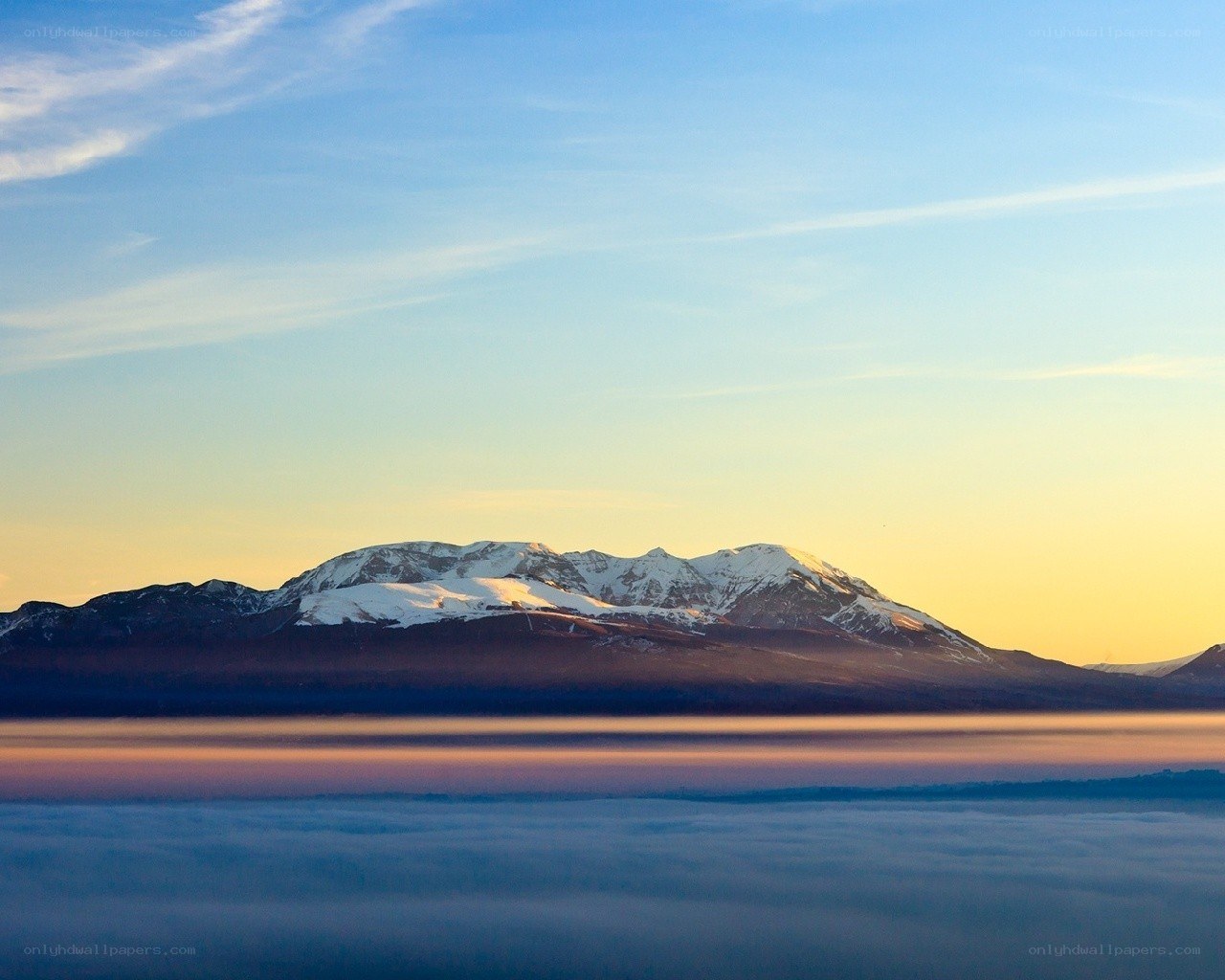 Snow-capped mountain at sunrise