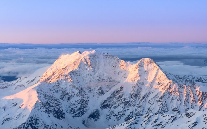 Snow-capped mountain at sunrise