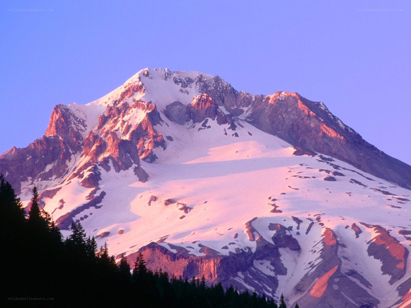 Snow-capped mountain at sunrise