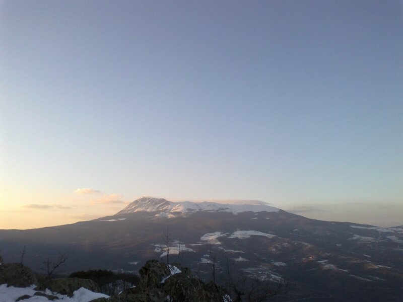 Snow-capped mountain at sunset