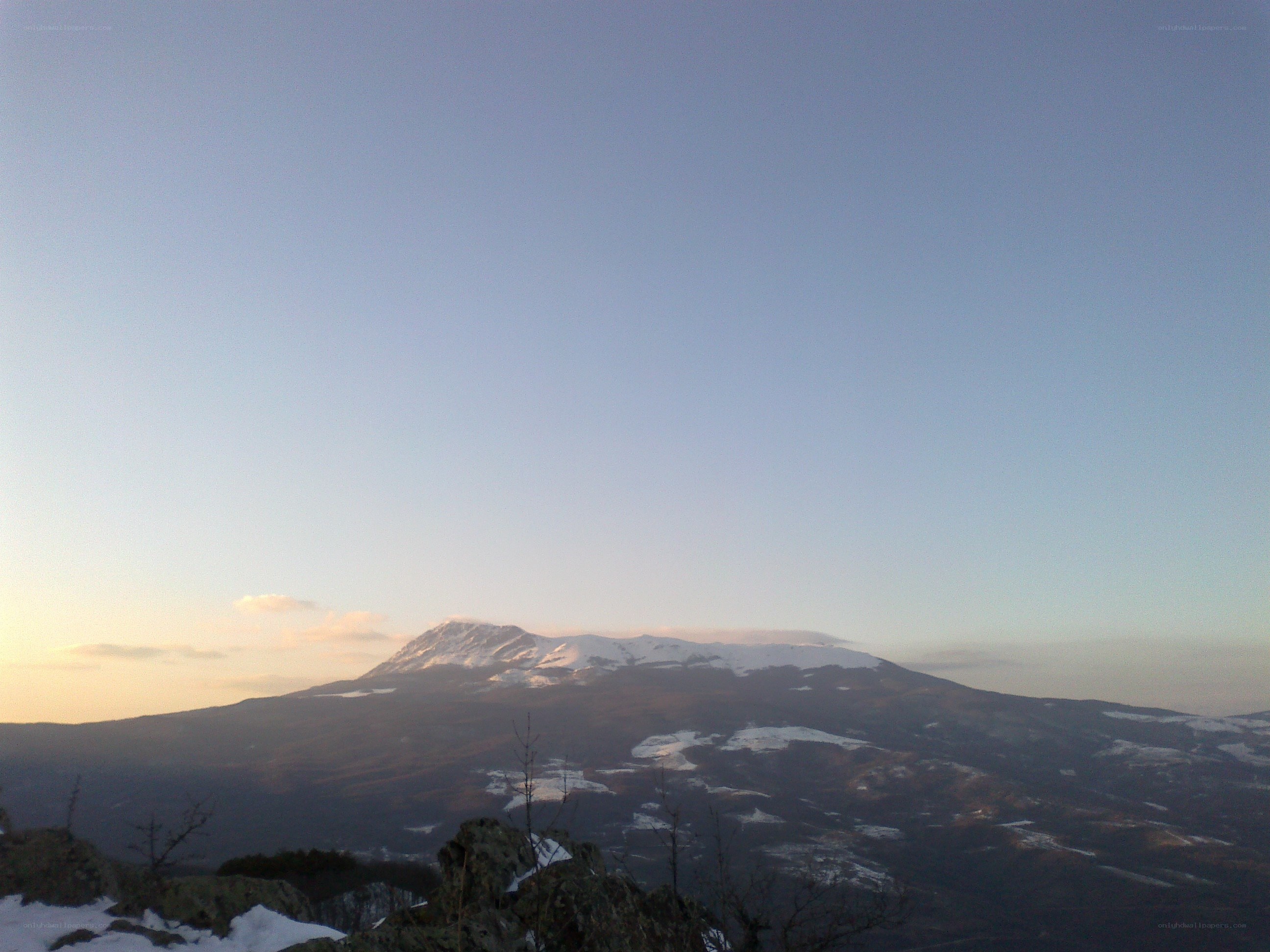 Snow-capped mountain at sunset