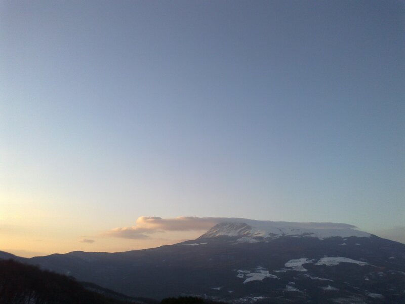 Snow-capped mountain at sunset