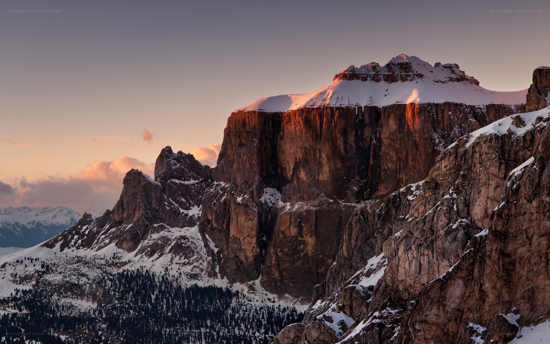 Snow-capped mountain at sunset
