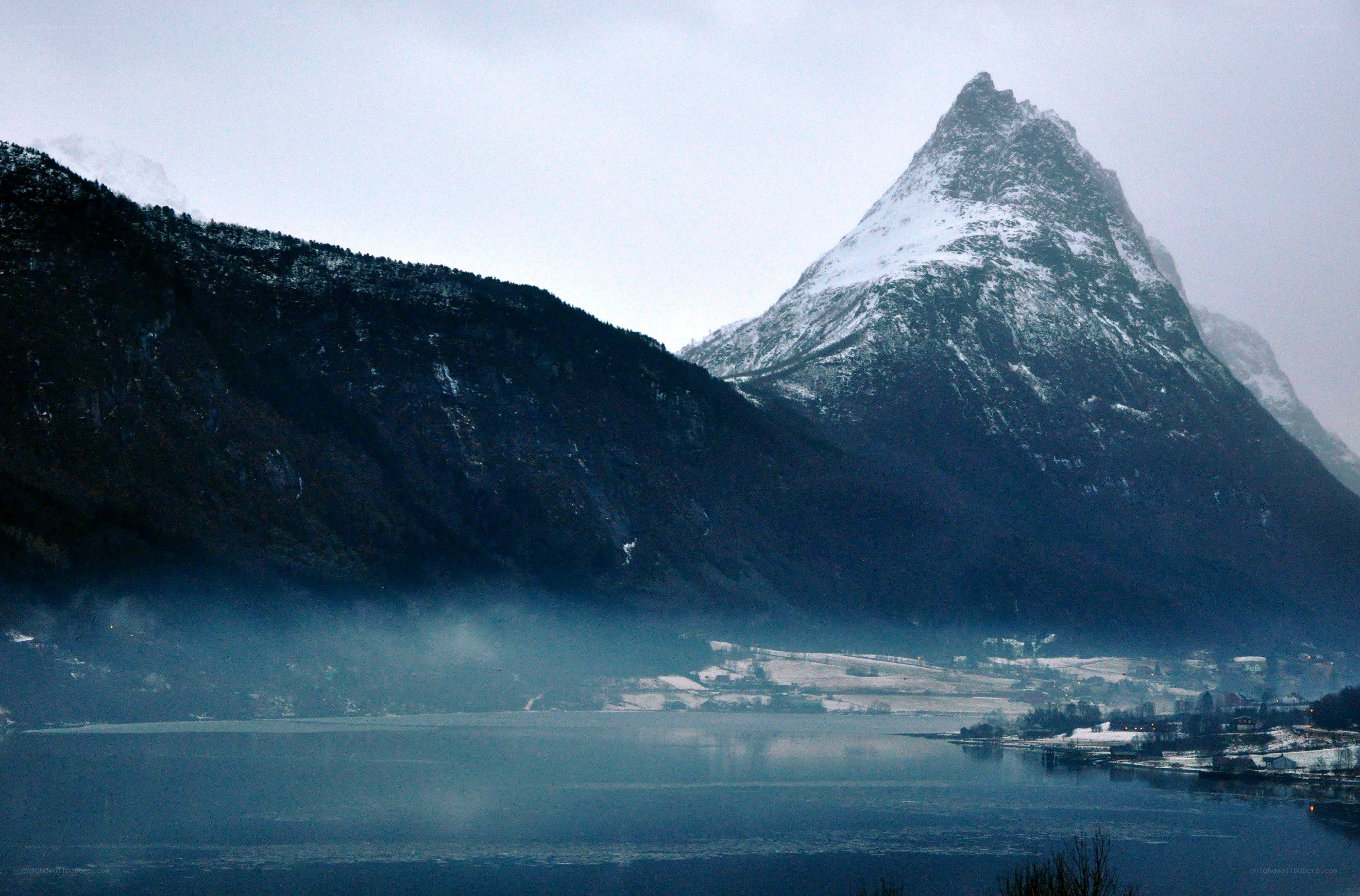 snow-capped mountain by a fjord