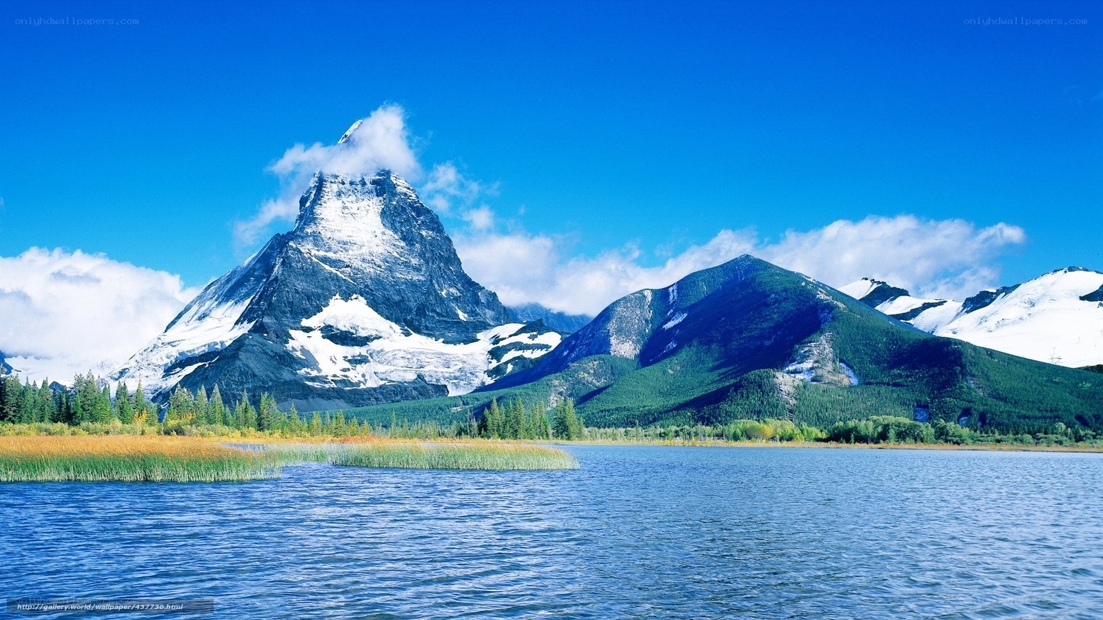Snow-capped mountain by a lake