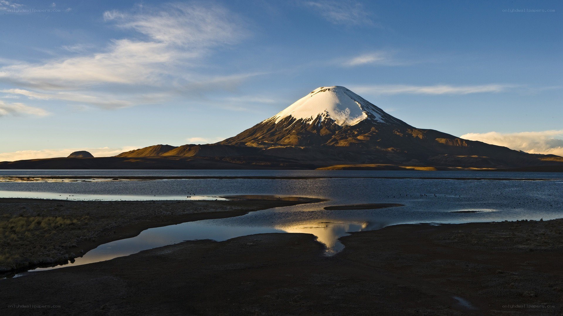 Snow-capped mountain by a lake