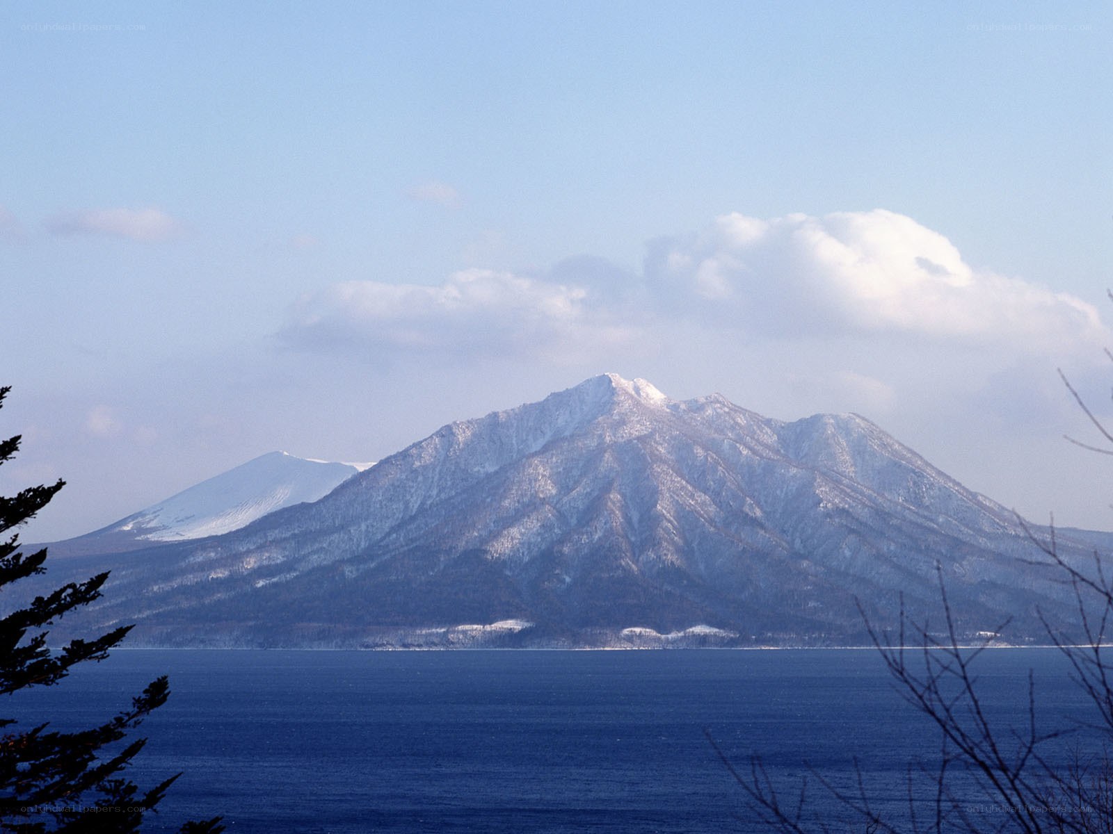 Snow-capped mountain by a lake