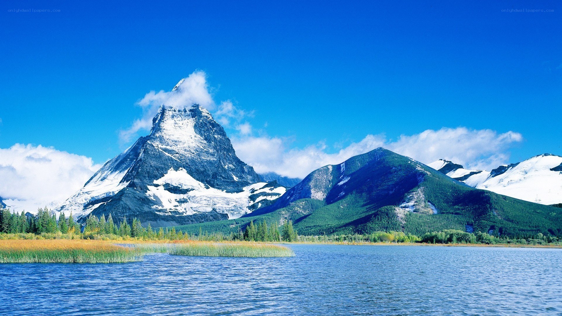 Snow-capped mountain by a lake